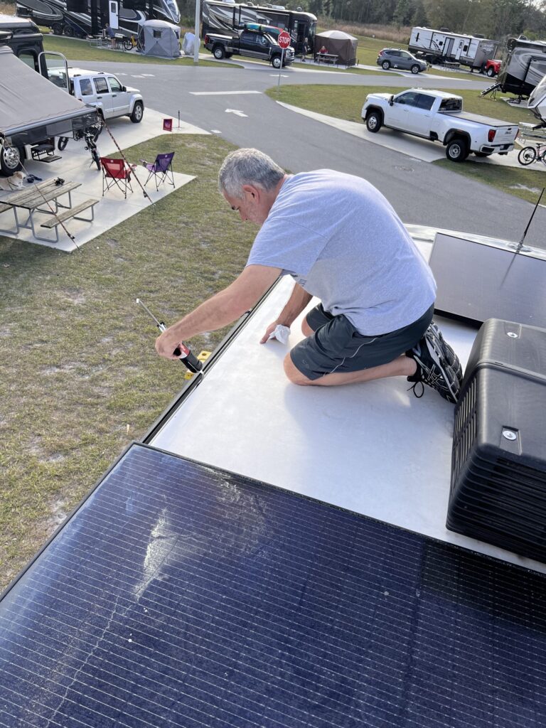Mike from RVBlogger walking on his RV roof while making a repair