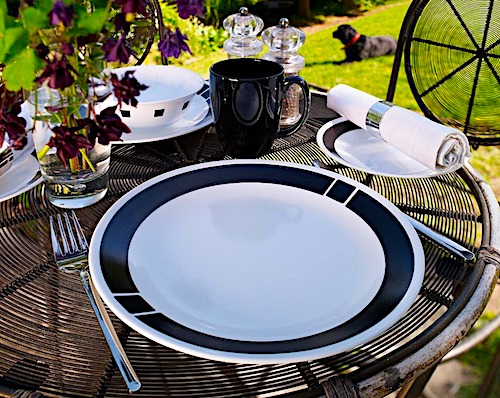 black and white corell dish set on a table outside