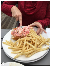 Susan eating a Lobster Roll and fries 