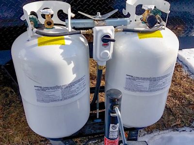 Two propane tanks at the front of a travel trailer