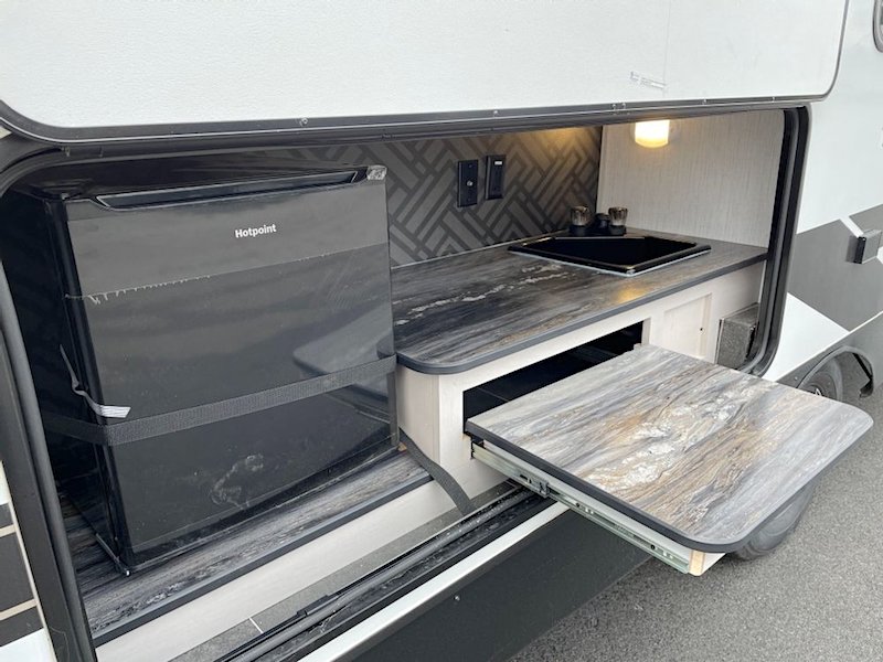Heartland Mallard Travel Trailer with an outdoor kitchen including griddle, fridge, and sink