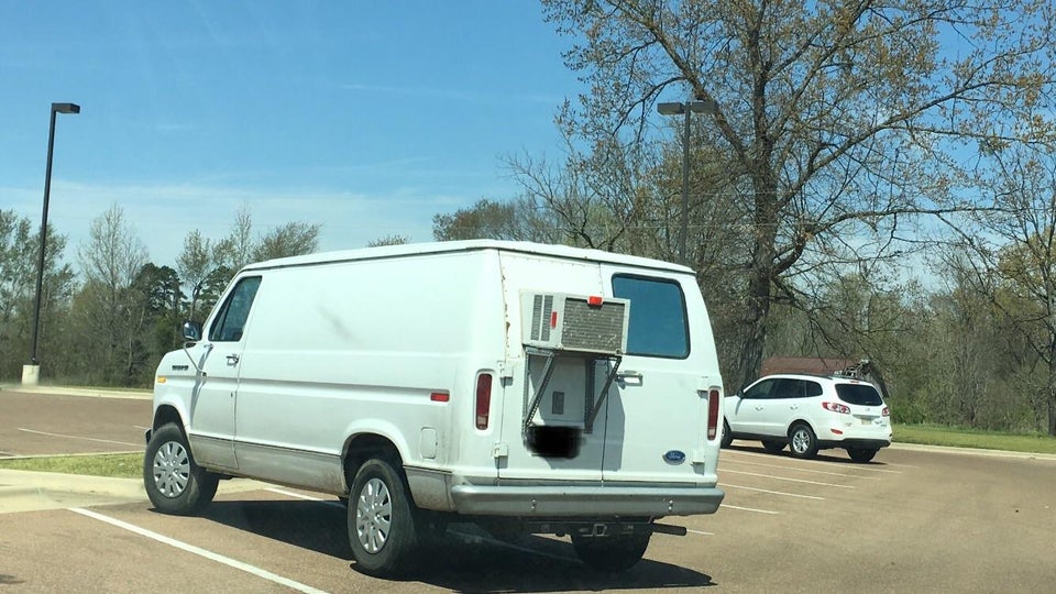 White van with a window air conditioner in rear door