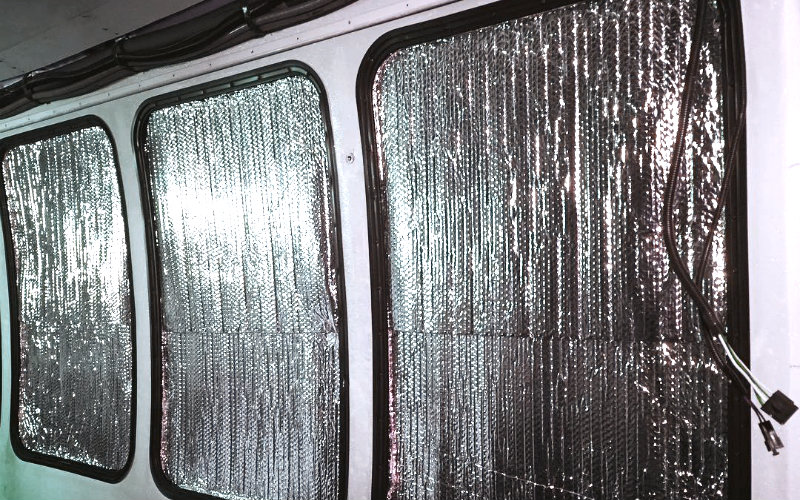 Reflectix window coverings in a camper van window