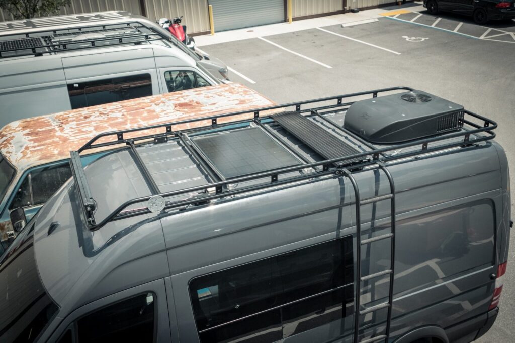 Aerial view of an adjustable roof rack by Freedomvango on a gray Mercedes Sprinter van
