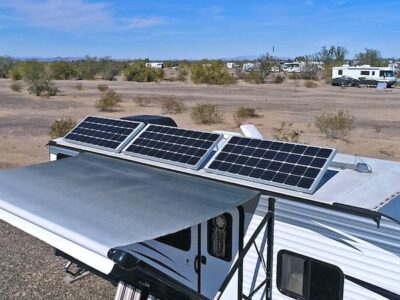 RV with awning out and solar panels on the roof