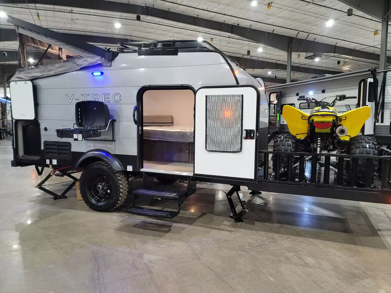 The Viking V-Trek V4-DSO is one of the best pop up campers with a toy hauler. The toy hauler is a deck on the front that is carrying an ATV.