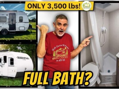mike pointing over his shoulder at 2 small travel trailers under 3500 lbs