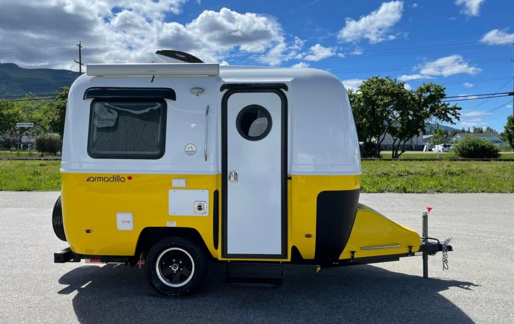 This fiberglass travel trailer by Armadillo is yellow and white on the outside