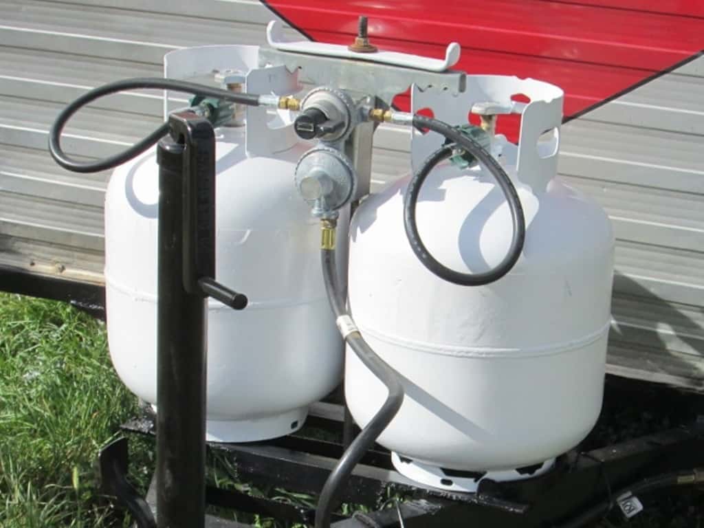 Two propane tanks on the front of a travel trailer