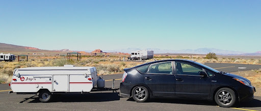 small car towing a pop-up camper