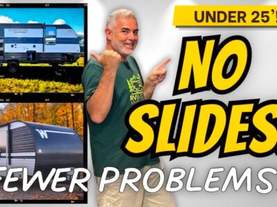 mike pointing to two travel trailers with no slides that are under 25 feet long
