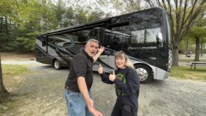 mike and susan from rvblogger standing in front of their new Class a rv